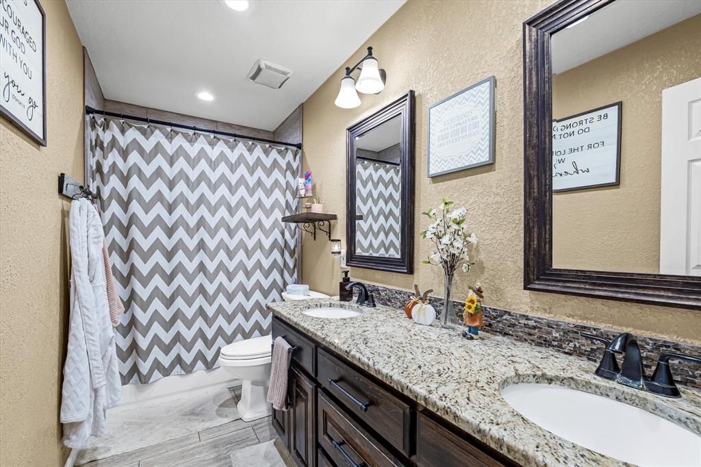 134 Thiele Road Lorena, TX 76655 - Photo 26 of 37 a bathroom with a granite countertop sink mirror vanity and toilet