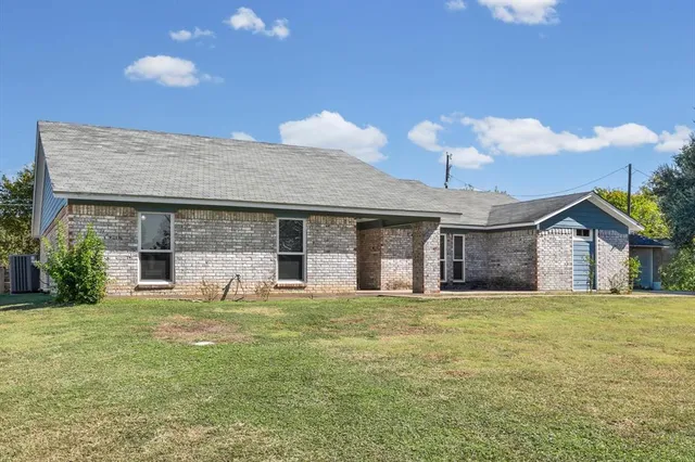 a view of a house with a yard and a garage