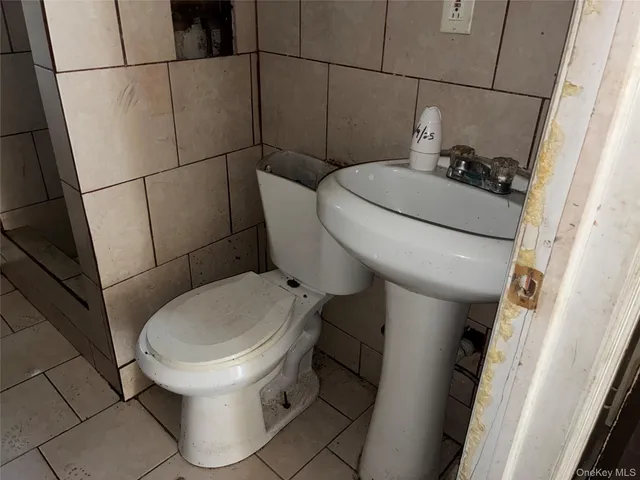 a white toilet sitting next to a small sink