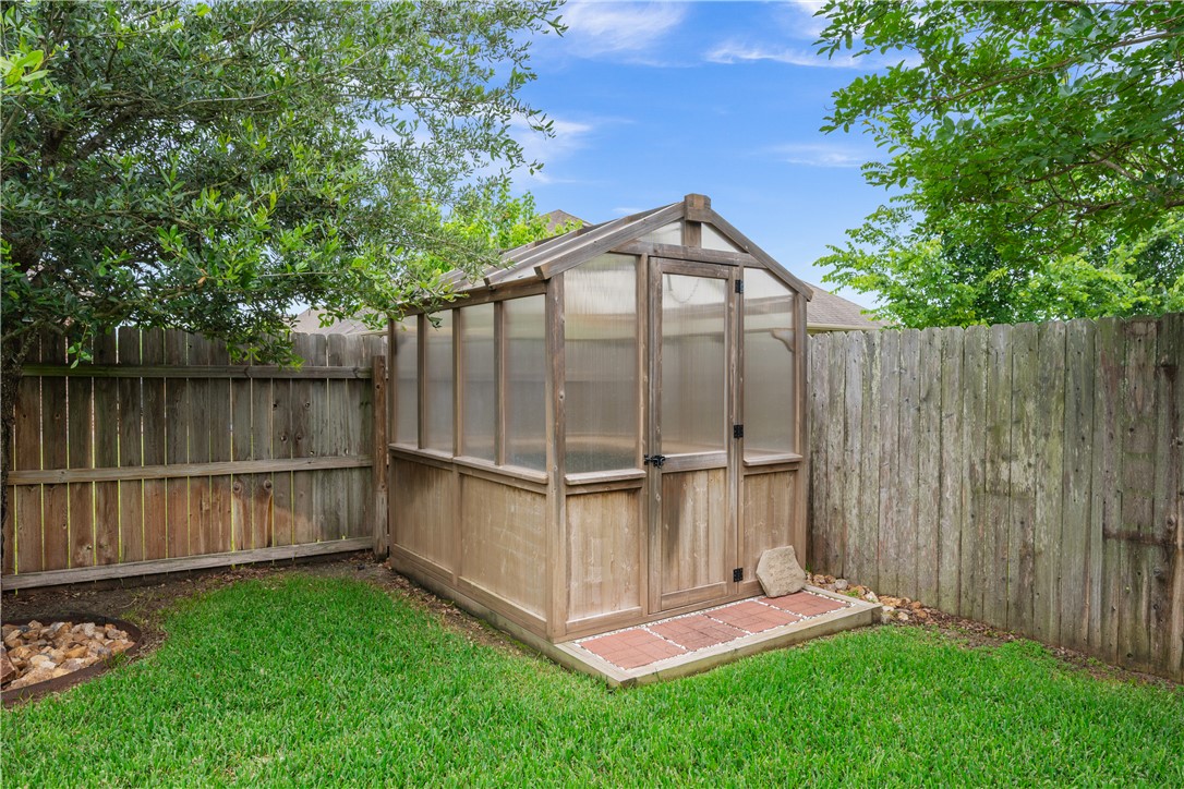 3085 Archer Circle Bryan, TX 77808 - Photo 29 of 31 a view of a backyard with a small cabin and a chair