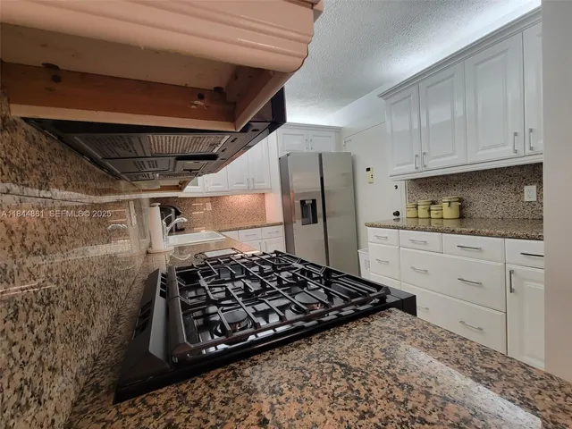 a kitchen with a stove and a refrigerator