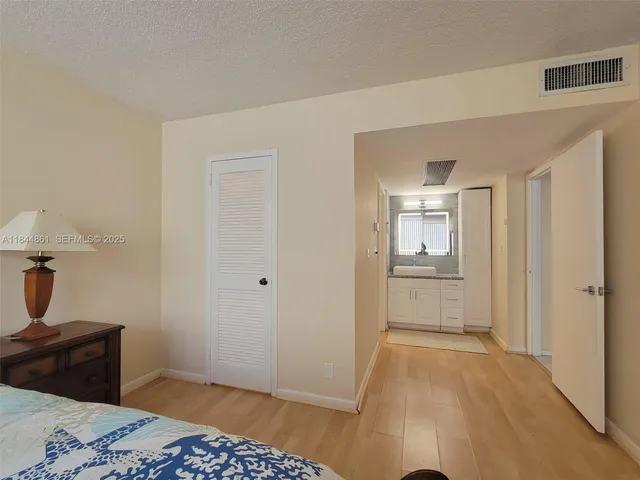 a bedroom with a bed and a lamp