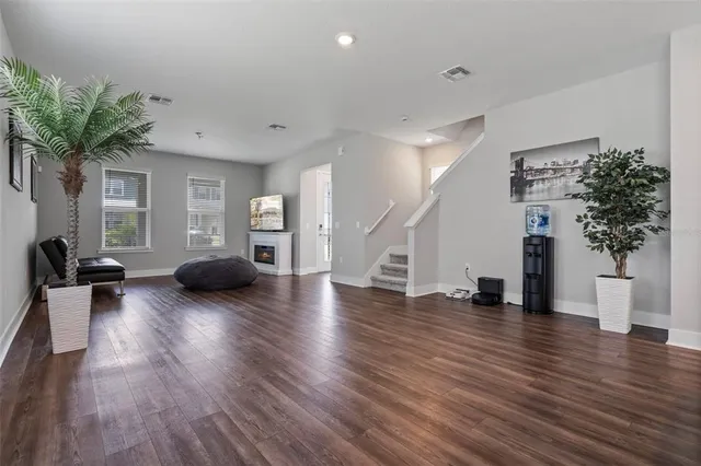 a view of a kitchen with stainless steel appliances granite countertop a stove a refrigerator a sink dishwasher and a refrigerator with wooden floor