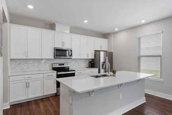 a kitchen with a sink and a stove top oven