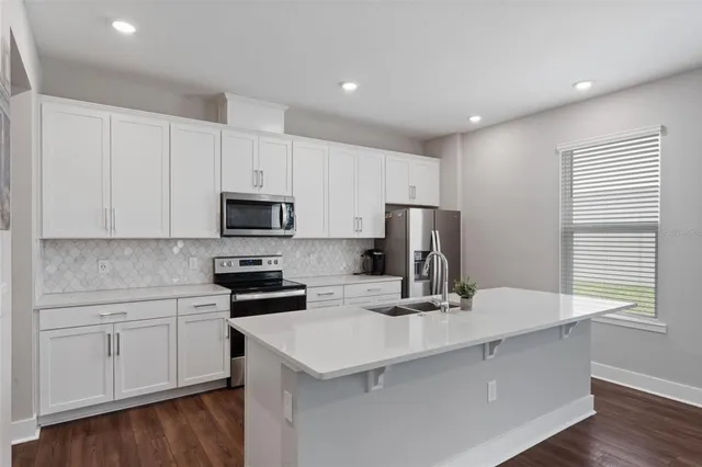 a kitchen with a sink and a stove top oven