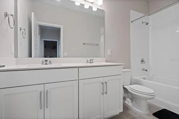 a white toilet sitting next to a bath tub