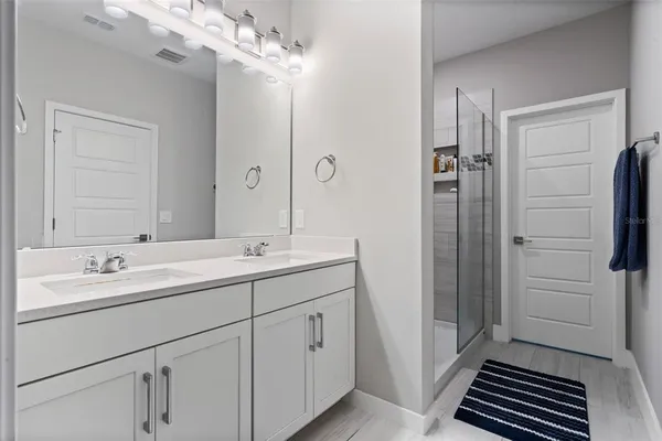 a bathroom with a glass shower door