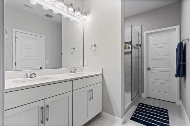 a bathroom with a glass shower door