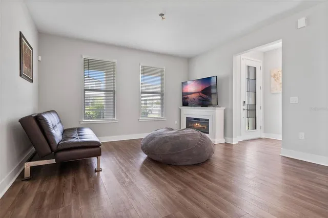 a living room with furniture and a wooden floor