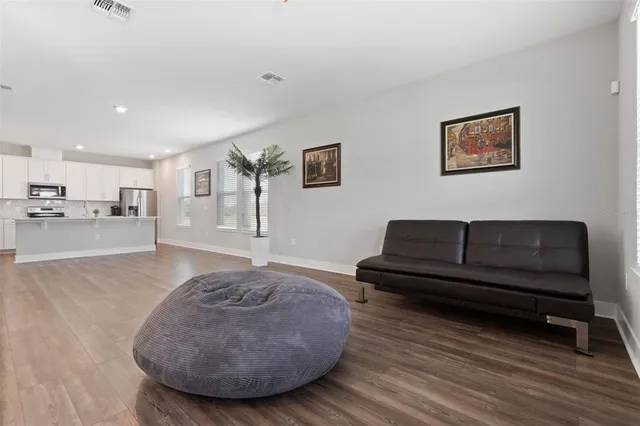 a view of kitchen with furniture and wooden floor