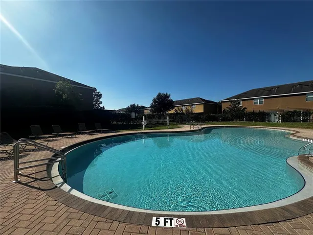 a view of a swimming pool with a yard