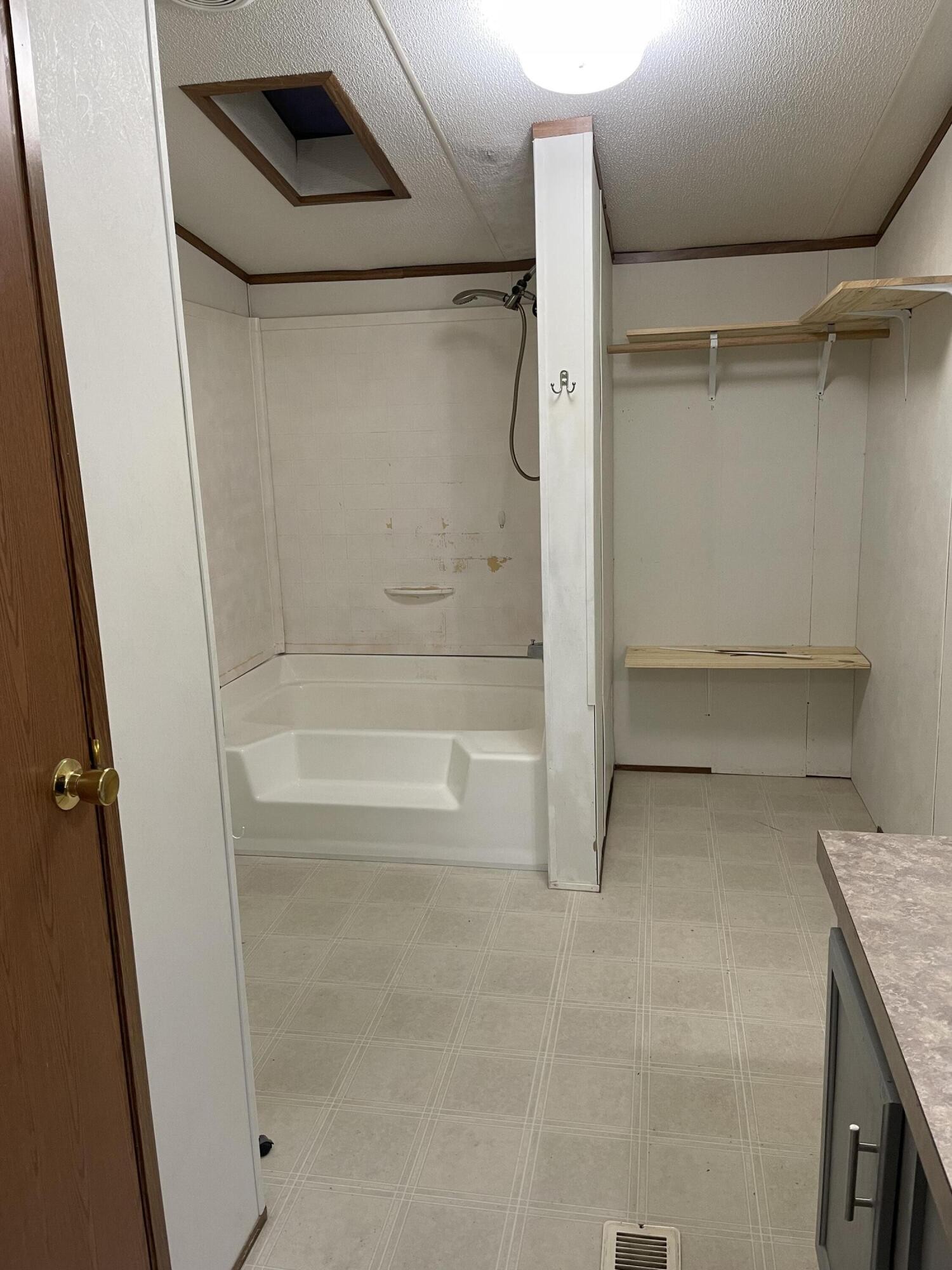 122 Haddock Lane Benton, TN 37307 - Photo 15 of 23 a bathroom with a granite countertop sink a toilet and shower