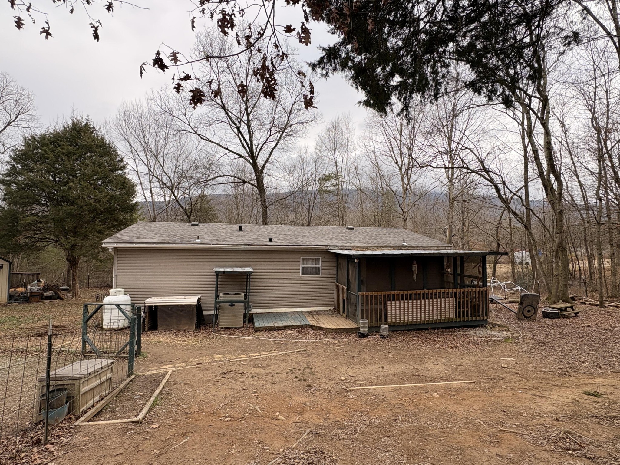 122 Haddock Lane Benton, TN 37307 - Photo 2 of 23 a view of a house with backyard and a tree