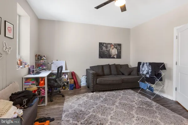 a living room with furniture and a gym cycle