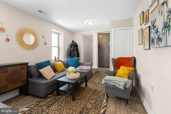 a living room with furniture and wooden floor