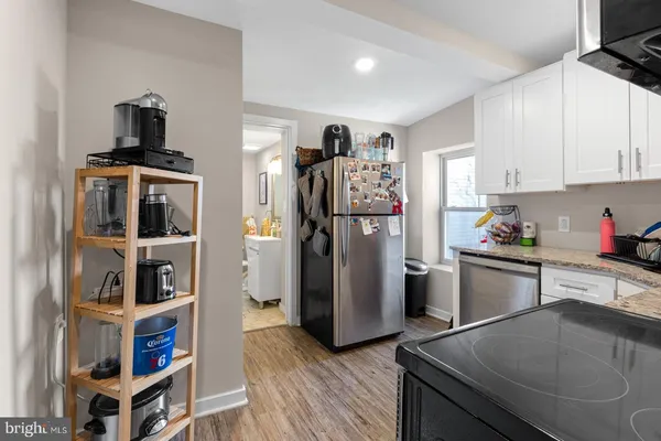 a kitchen with a refrigerator and a stove top oven