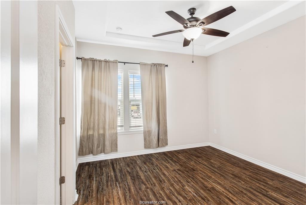 2108 Cavitt Avenue, Unit A Bryan, TX 77801 - Photo 9 of 14 wooden floor in an empty room with a window