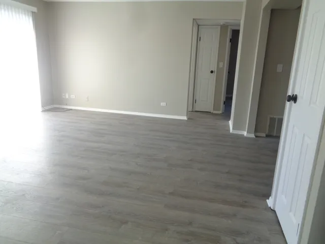 a view of hallway with wooden floor