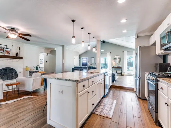 a large kitchen with granite countertop lots of counter top space