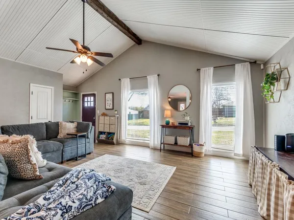 a living room with furniture and wooden floor