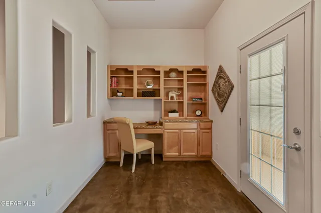a view of a workspace with furniture and wooden floor