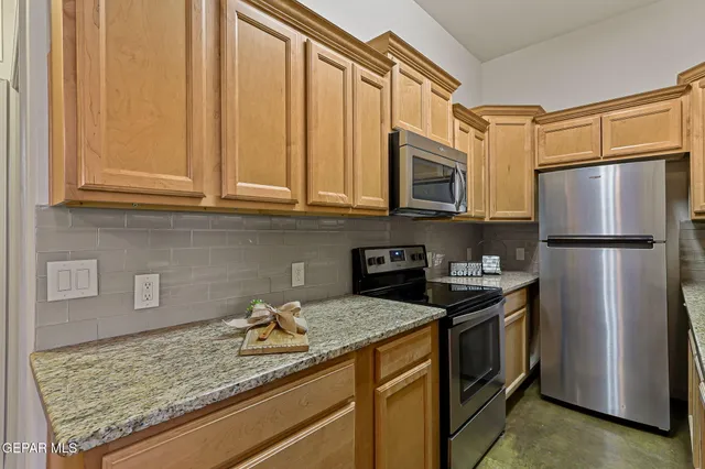 a kitchen with a sink a stove and a refrigerator