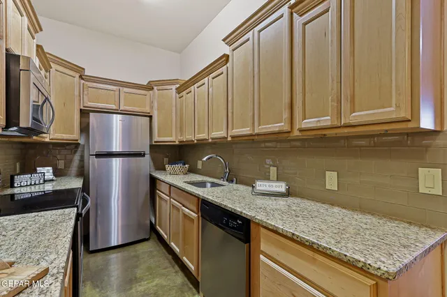 a kitchen with a sink stove and cabinets