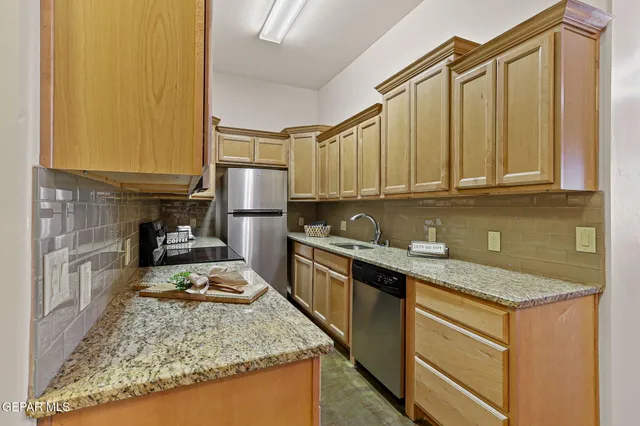 a spacious bedroom with a bed and a chandelier