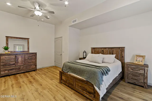a bedroom with a bed and a chandelier