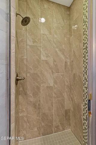 a kitchen with a granite countertop sink and white cabinets