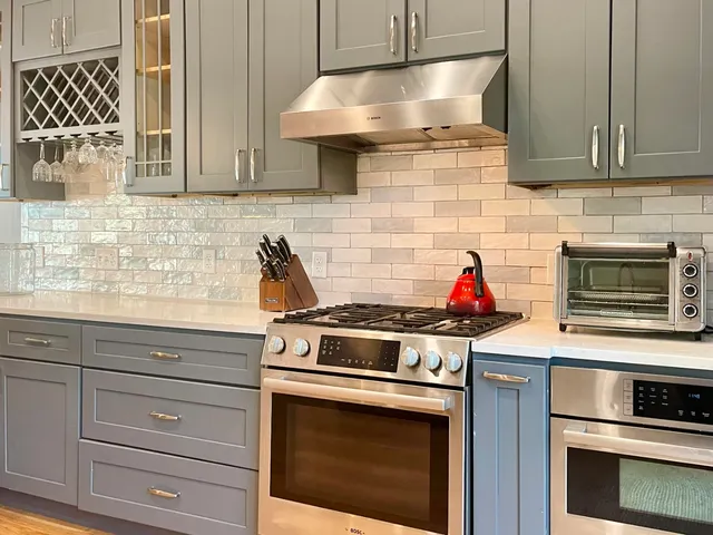 a stove top oven sitting inside of a kitchen