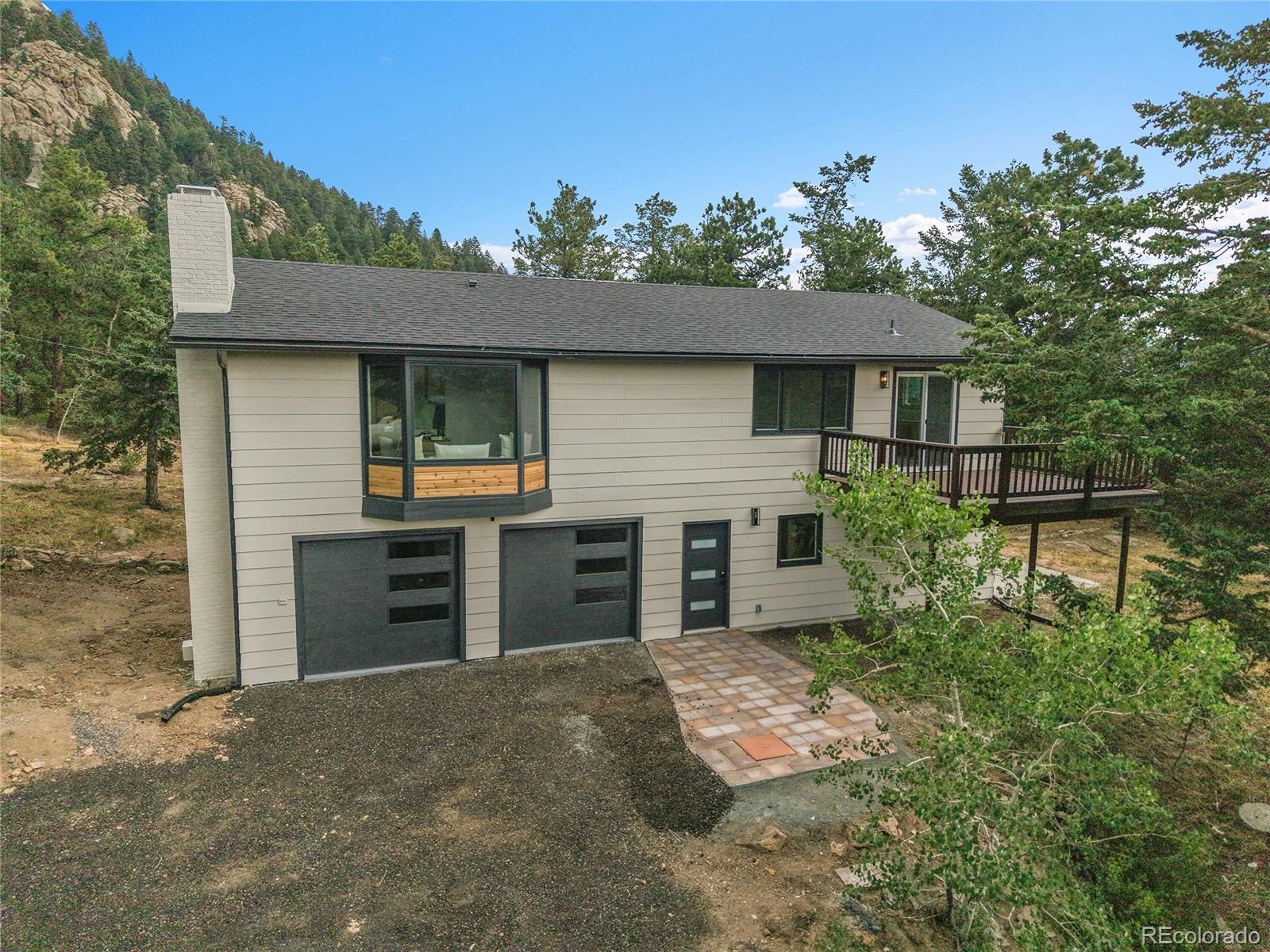 front view of a house with a yard and garage