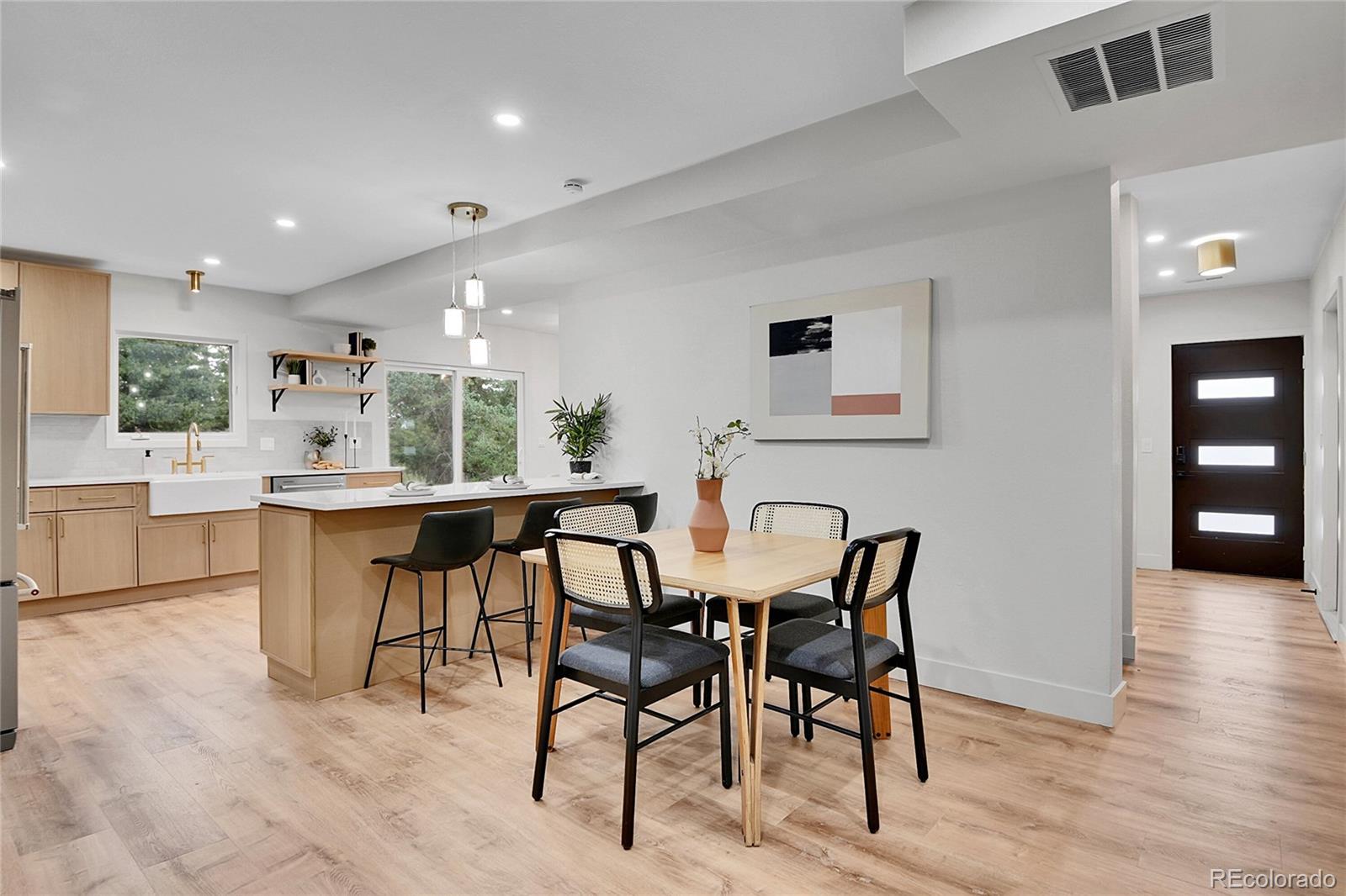 8919 South Hillview Road Morrison, CO 80465 - Photo 13 of 50 a kitchen with stainless steel appliances kitchen island granite countertop a dining table chairs and view living room