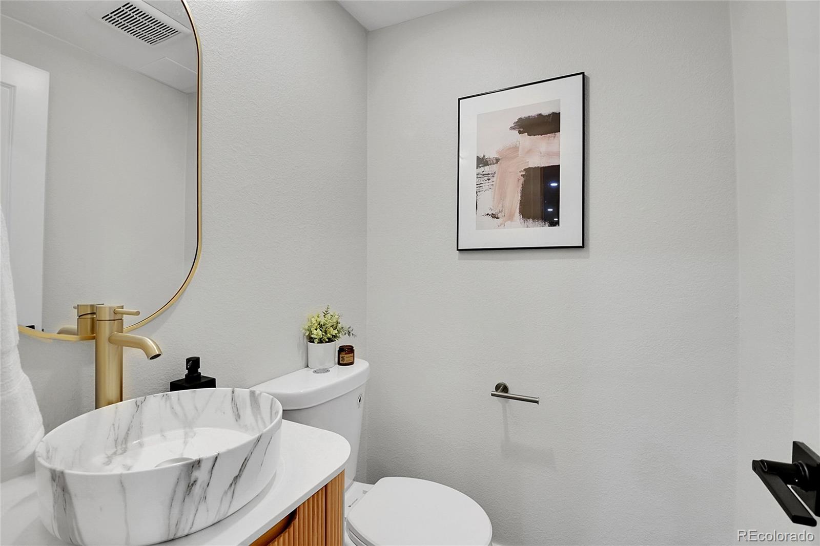 8919 South Hillview Road Morrison, CO 80465 - Photo 15 of 50 a bathroom with a toilet and a sink