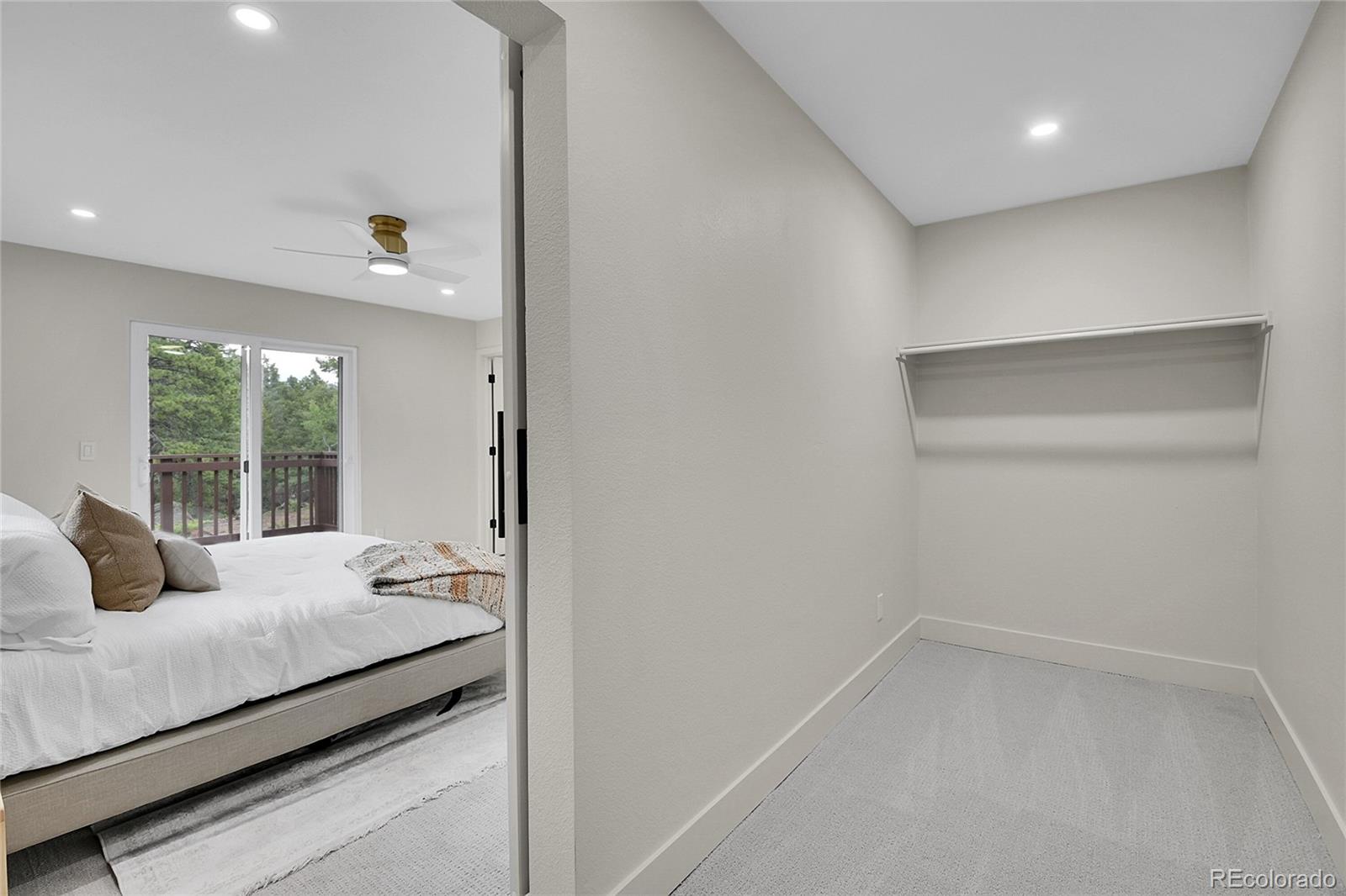 8919 South Hillview Road Morrison, CO 80465 - Photo 31 of 50 a bedroom with a bed and large windows