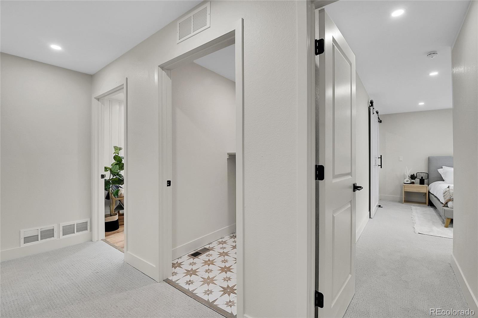 8919 South Hillview Road Morrison, CO 80465 - Photo 32 of 50 a view of a hallway with bathroom and wooden floor