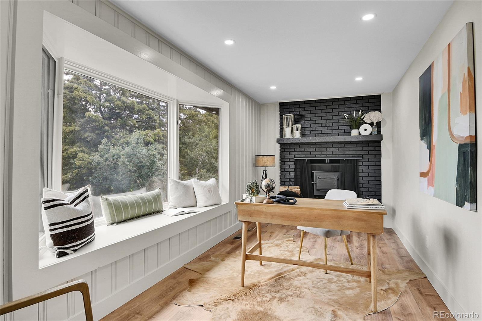8919 South Hillview Road Morrison, CO 80465 - Photo 33 of 50 a dining room with furniture a fireplace and wooden floor
