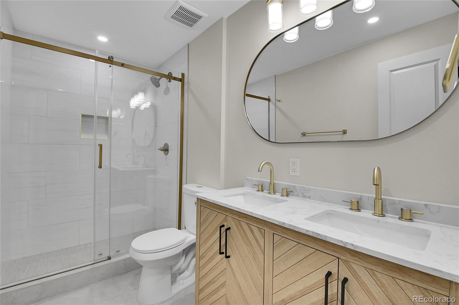 8919 South Hillview Road Morrison, CO 80465 - Photo 38 of 50 a bathroom with a sink a toilet and shower