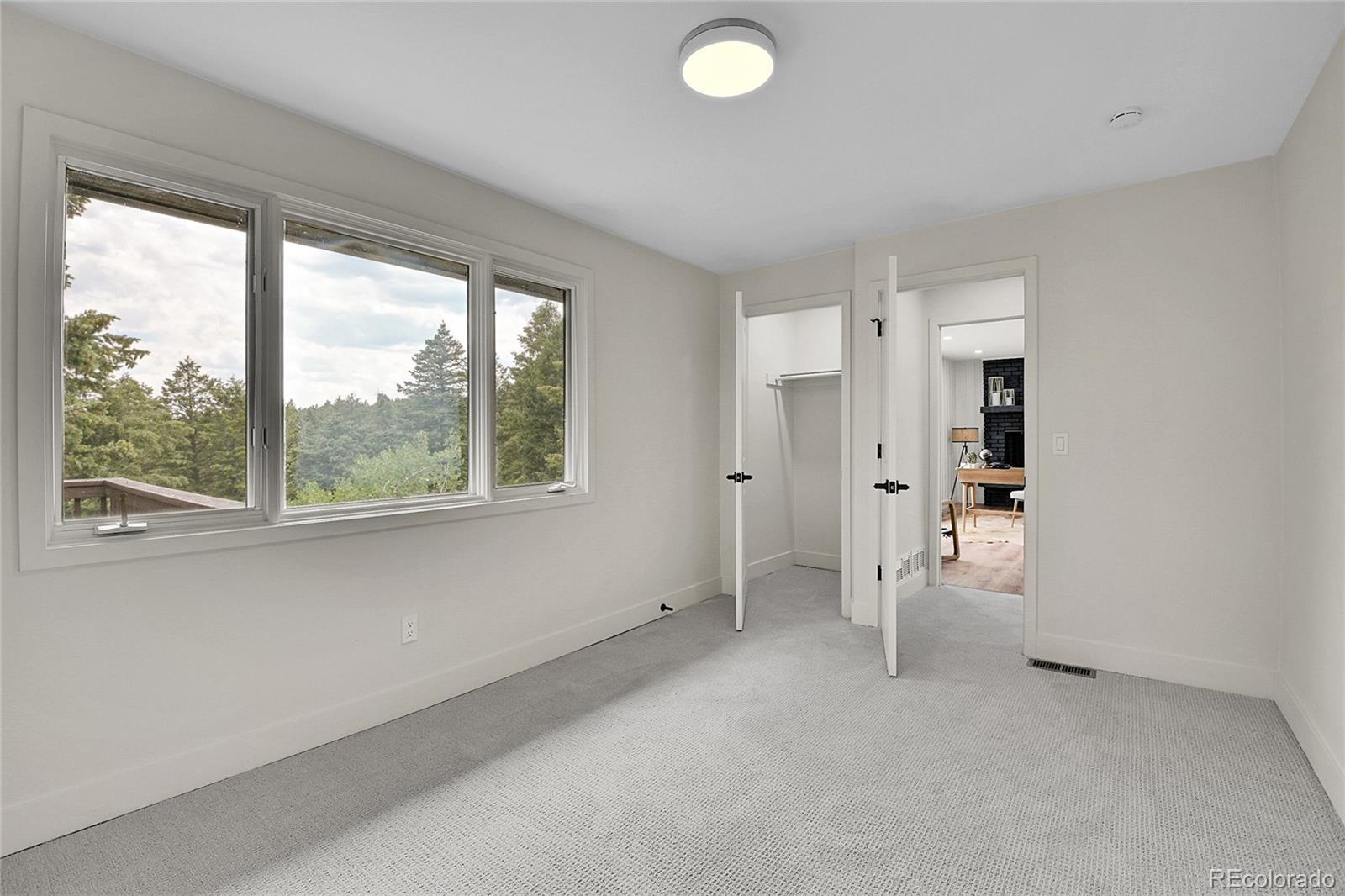8919 South Hillview Road Morrison, CO 80465 - Photo 40 of 50 a view of empty room with a window and a livingroom