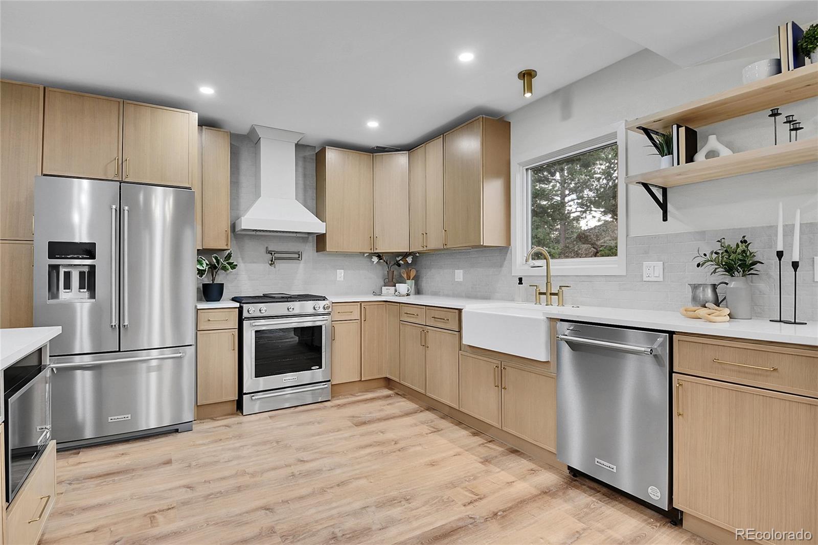 8919 South Hillview Road Morrison, CO 80465 - Photo 9 of 50 a kitchen with white cabinets stainless steel appliances and a window