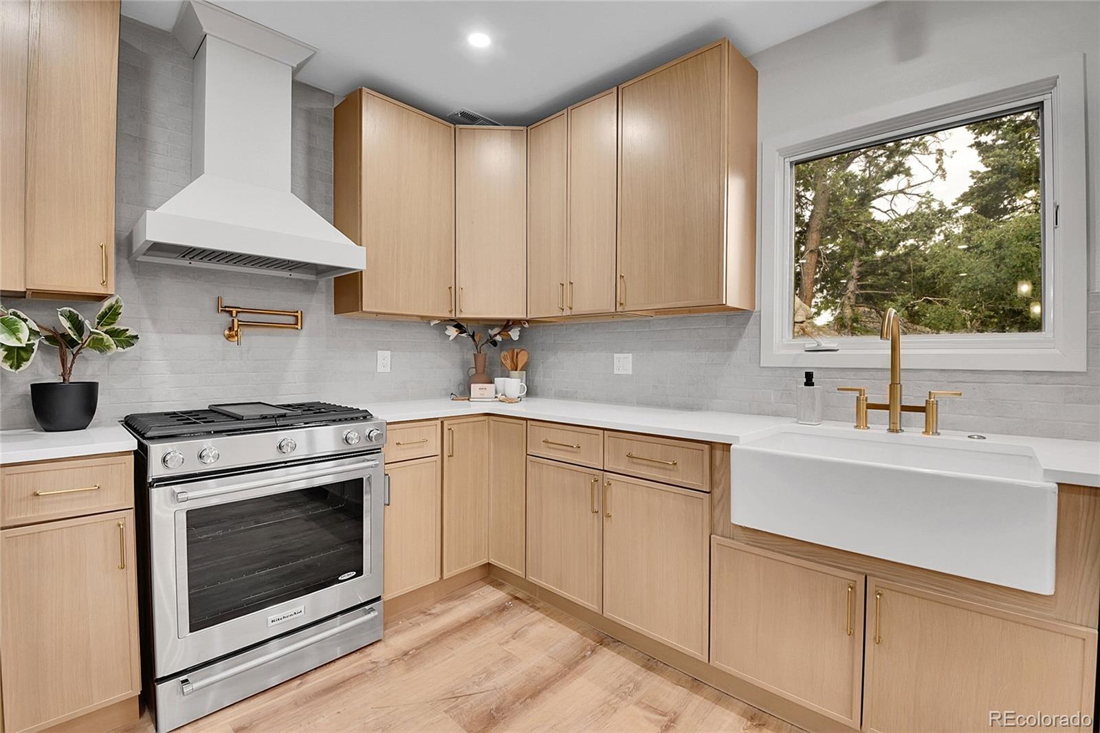 8919 South Hillview Road Morrison, CO 80465 - Photo 10 of 50 a kitchen with a sink stove and cabinets