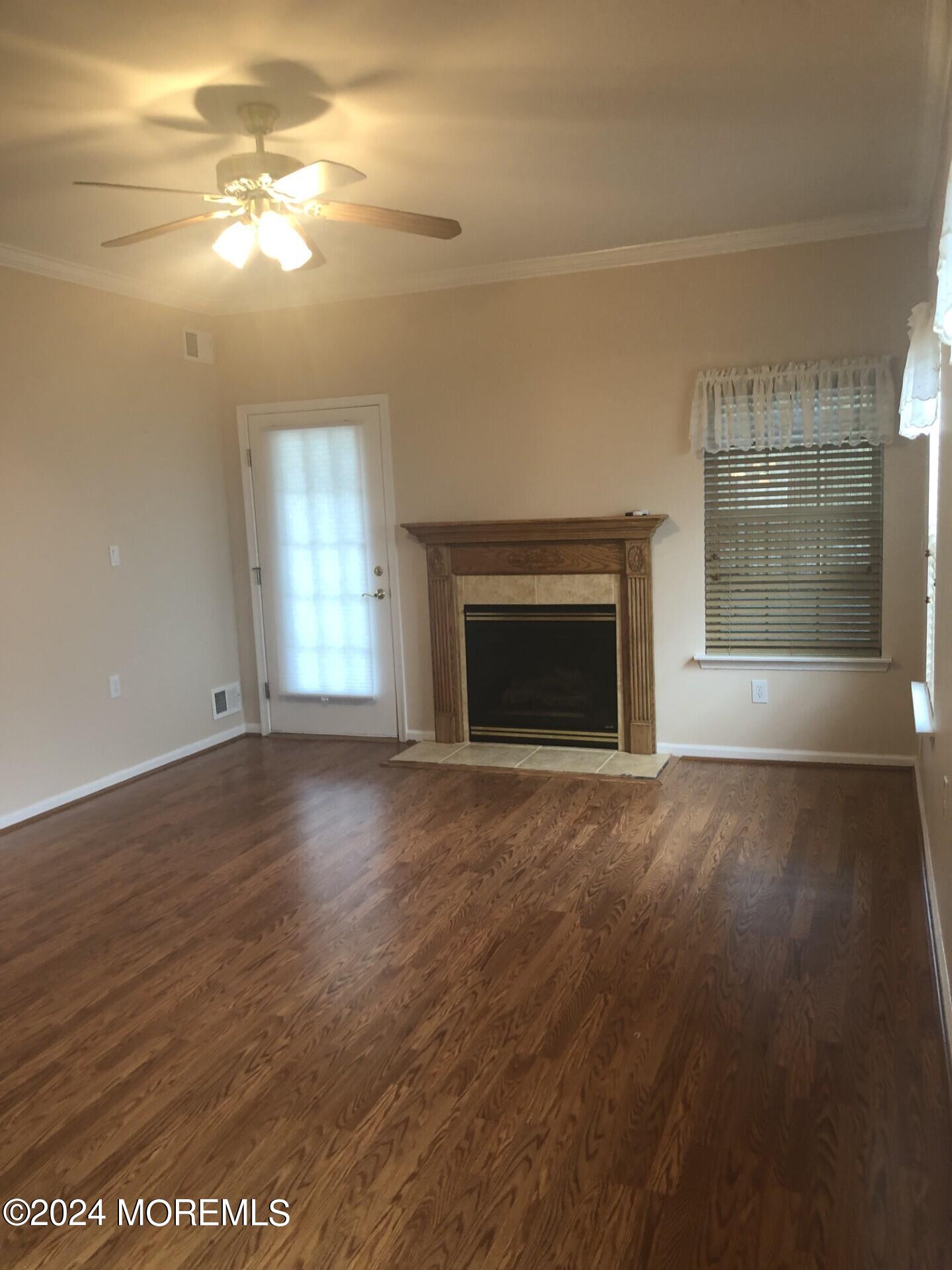 9 Modena Court Manchester Township, NJ 08759 - Photo 5 of 10 an empty room with windows and fireplace