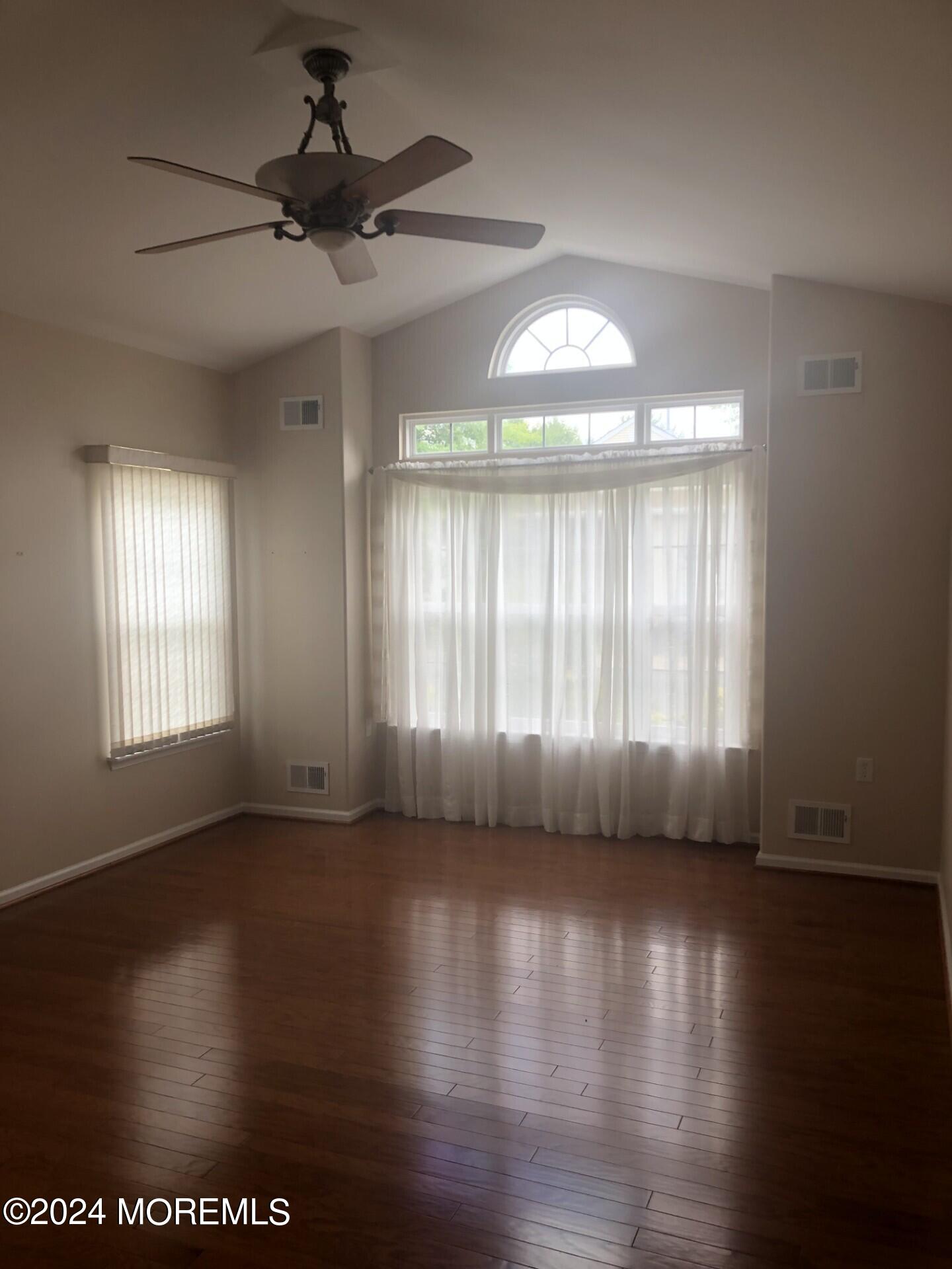 9 Modena Court Manchester Township, NJ 08759 - Photo 6 of 10 a view of an empty room with wooden floor and a window