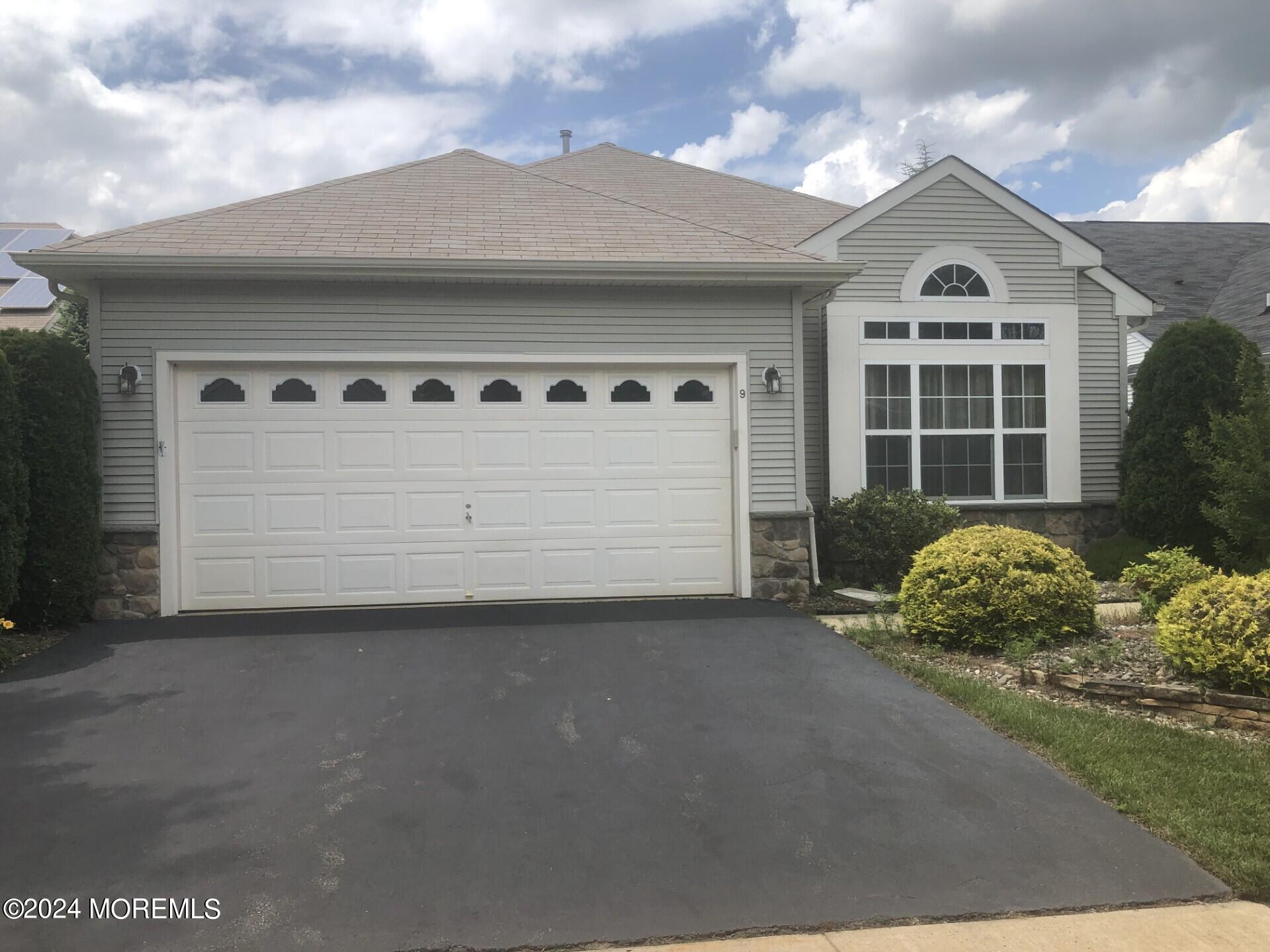 9 Modena Court Manchester Township, NJ 08759 - Photo 10 of 10 a front view of a house with a yard and garage