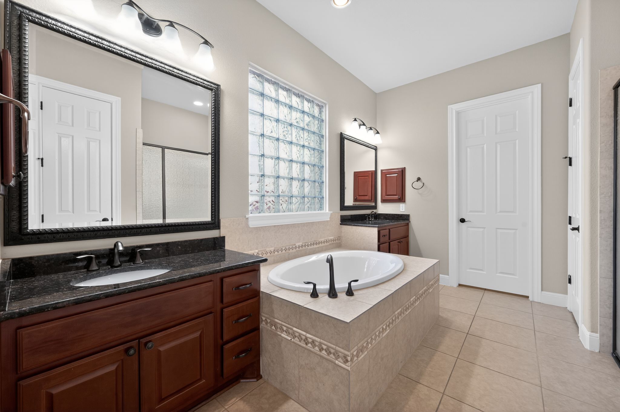 3903 Remington Road Cedar Park, TX 78613 - Photo 21 of 40 a bathroom with a tub sink and mirror
