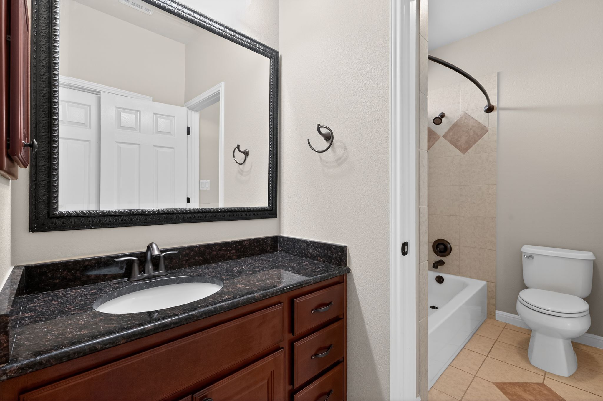3903 Remington Road Cedar Park, TX 78613 - Photo 29 of 40 a bathroom with a granite countertop sink a mirror and a toilet