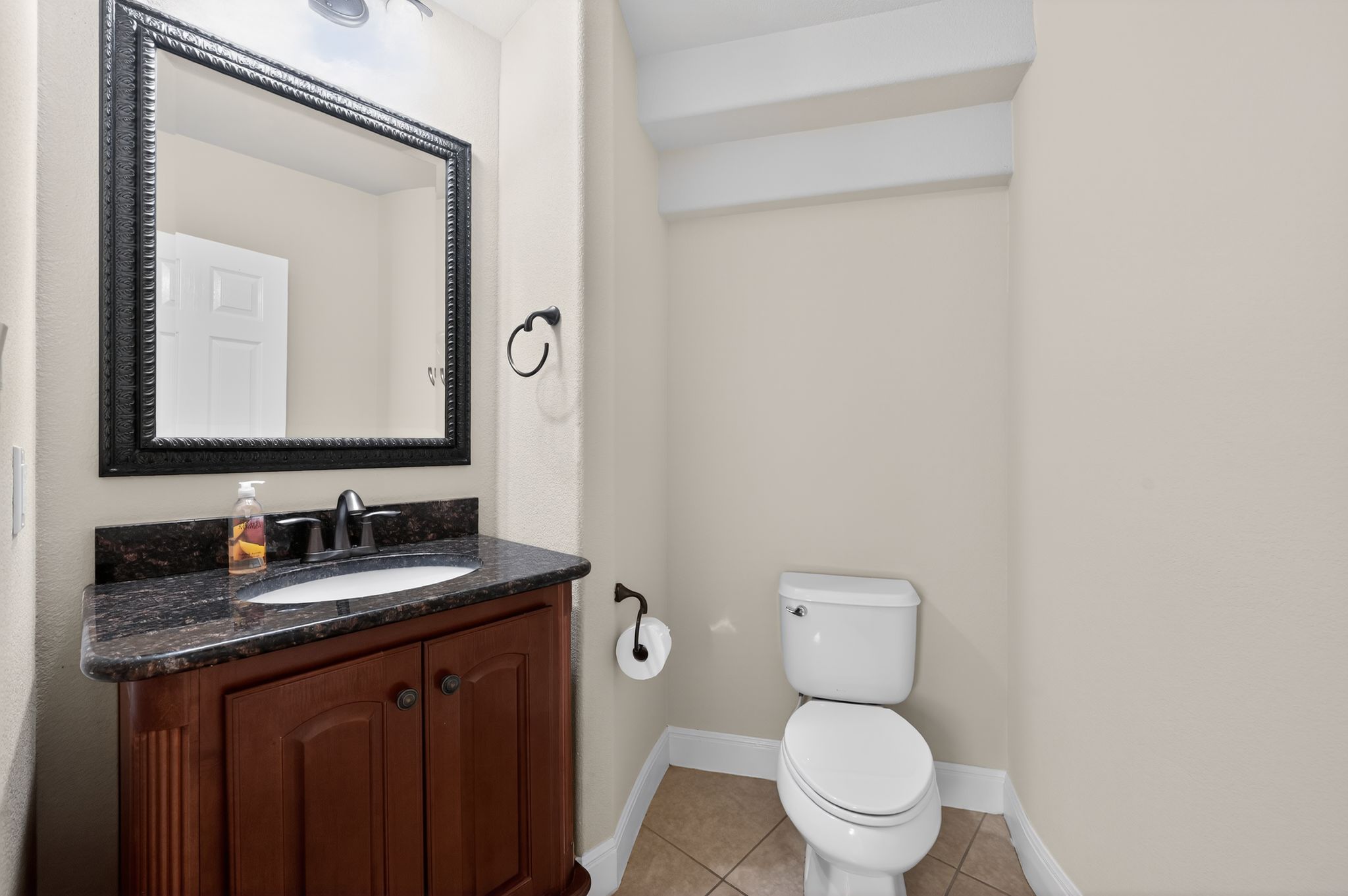 3903 Remington Road Cedar Park, TX 78613 - Photo 32 of 40 a bathroom with a granite countertop toilet sink and mirror