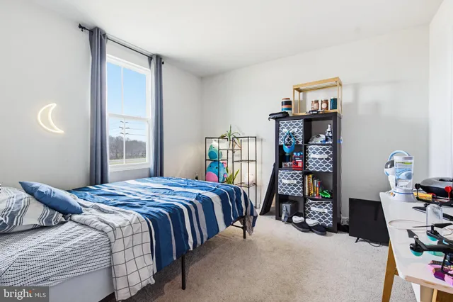 a bedroom with a bed furniture and a book shelf