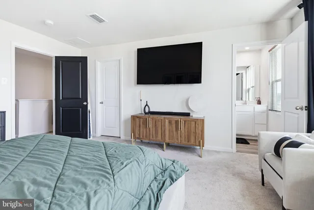 a bedroom with a bed and a flat screen television