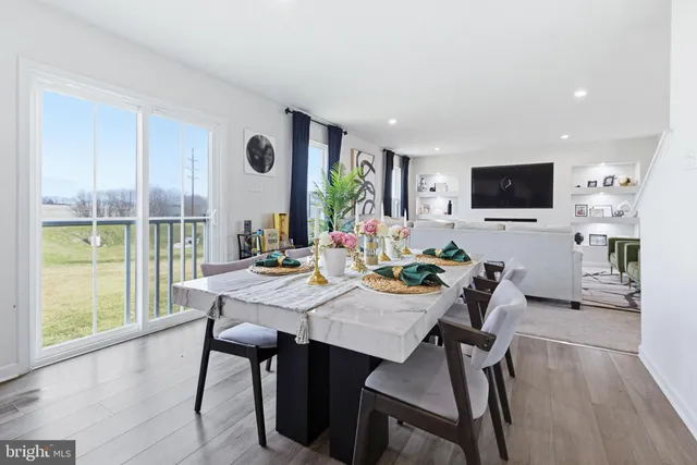a view of a dining room with furniture window and wooden floor